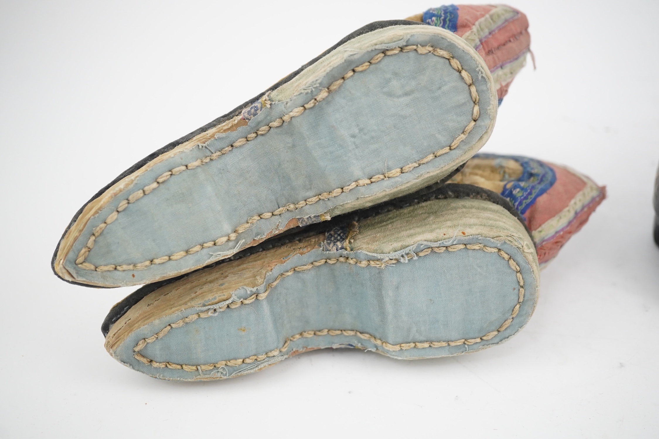 Three pairs of late 19th / early 20th century Chinese ladies embroidered silk shoes, for bound feet, one with sheep’s wool pom-poms, together with a similar a pair of silk embroidered ankle boots and pair of decorative r